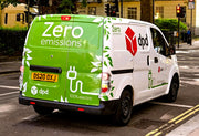 Electric van with 'Zero emissions' and 'dpd' branding on a city street.