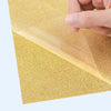 Gold glitter Vinyl Transfer with a hand lifting a corner