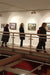 People observing art on a wall in an indoor setting