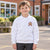 Child wearing a school uniform sweatshirt