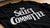A black band merch T-shirt with 'THE SELECT COMMITTEE' printed in large white serif letters across the chest, laid flat on a wooden surface.