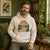A man wearing a custom organic hoodie with a print on the front.
