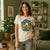 A woman wearing a custom organic T-shirt with a print on the front.
