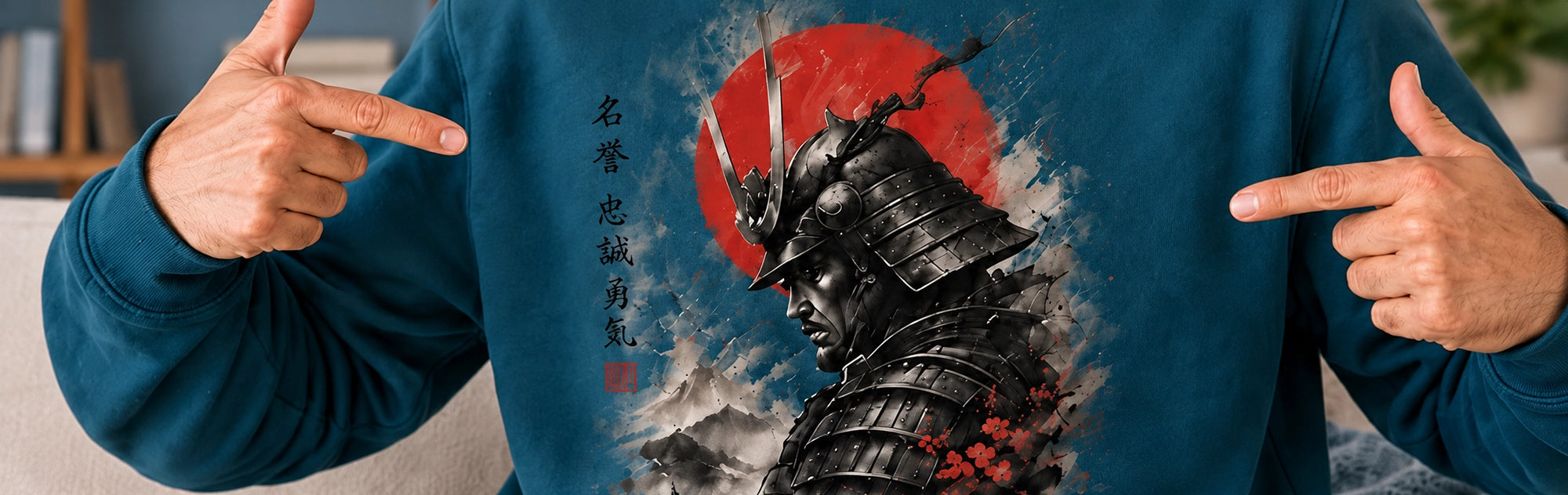 A person wearing a personalised sweatshirt with a large graphic print of a samurai helmet and a red sun, pointing at the design with both hands.